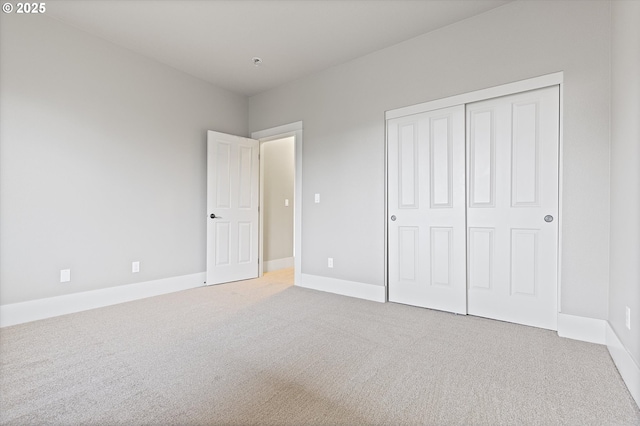 unfurnished bedroom featuring carpet and a closet