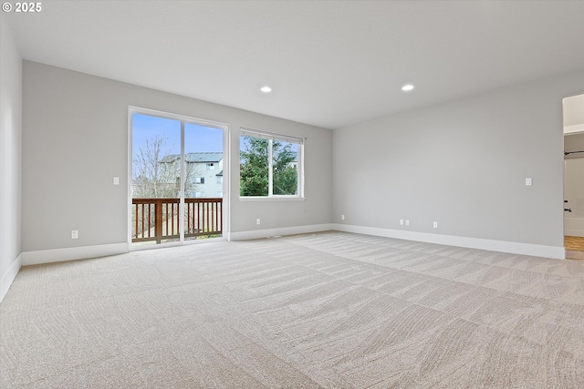 unfurnished room featuring light carpet