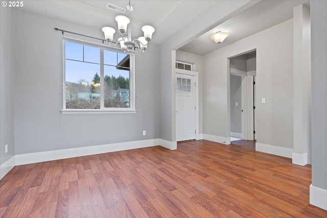 interior space with hardwood / wood-style flooring and a chandelier