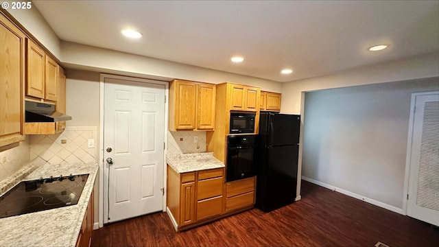 kitchen with light stone counters, dark hardwood / wood-style flooring, decorative backsplash, and black appliances