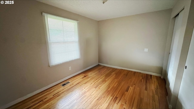 interior space featuring light hardwood / wood-style flooring and a textured ceiling