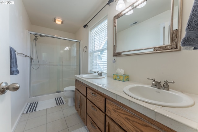 full bathroom with tile patterned flooring, visible vents, a sink, and a stall shower