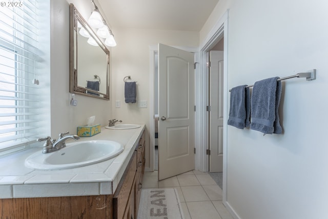 bathroom with double vanity, tile patterned flooring, and a sink
