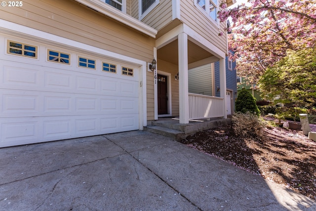 property entrance with concrete driveway and a porch