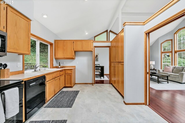 3870 Ashford Dr, Eugene, OR 97405 - kitchen featuring black appliances, a sink, vaulted ceiling, light countertops, and recessed lighting