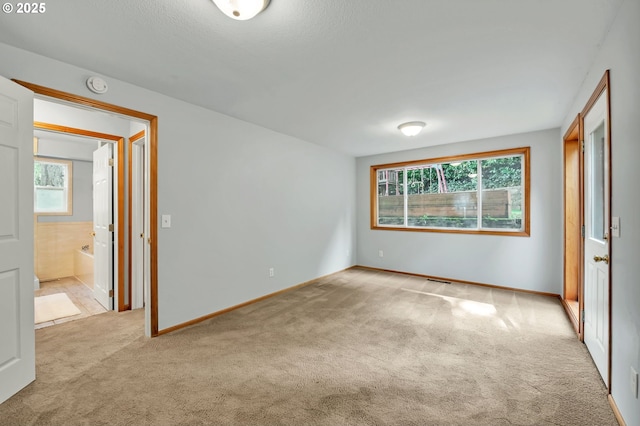 3870 Ashford Dr, Eugene, OR 97405 - unfurnished bedroom featuring carpet flooring, multiple windows, and baseboards