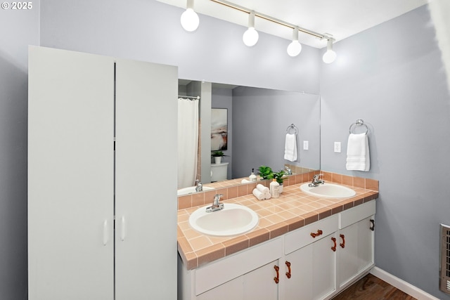 4460 SW Scholls Ferry Rd Unit 5, Portland, OR 97225 - full bath with double vanity, track lighting, and wood finished floors