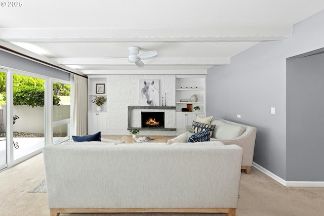 4460 SW Scholls Ferry Rd Unit 5, Portland, OR 97225 - living area featuring light colored carpet, beamed ceiling, a lit fireplace, and a ceiling fan