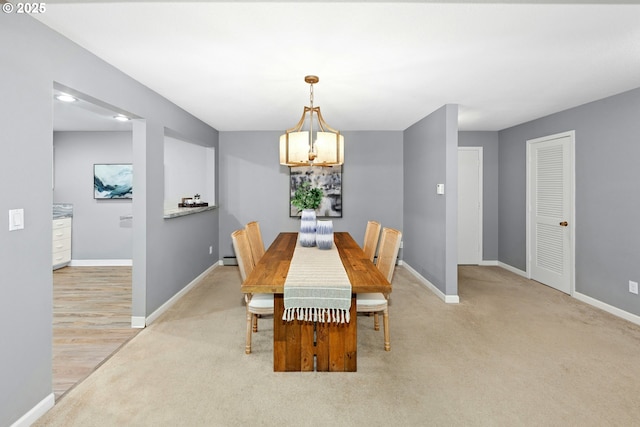 4460 SW Scholls Ferry Rd Unit 5, Portland, OR 97225 - dining room featuring light carpet, a chandelier, and a baseboard heating unit