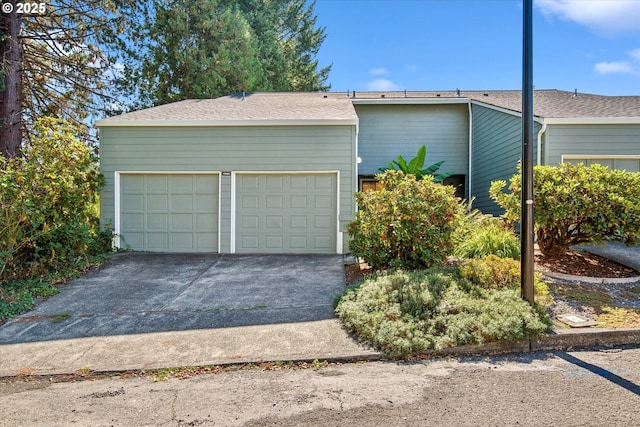 garage featuring concrete driveway