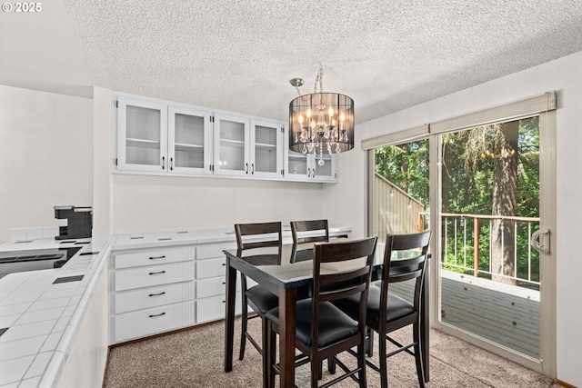 2547 Brittania Pl, Eugene, OR 97405 - dining area featuring a chandelier, light carpet, and a textured ceiling