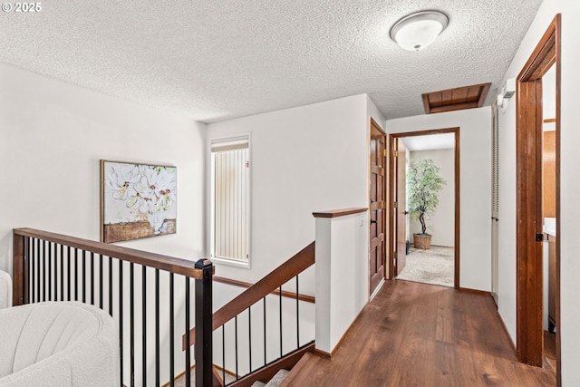 2547 Brittania Pl, Eugene, OR 97405 - corridor with an upstairs landing, wood finished floors, a textured ceiling, and healthy amount of natural light