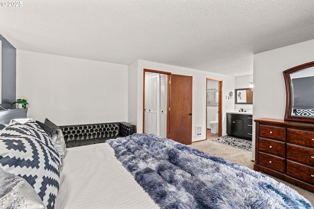 2547 Brittania Pl, Eugene, OR 97405 - carpeted bedroom with a textured ceiling and ensuite bath