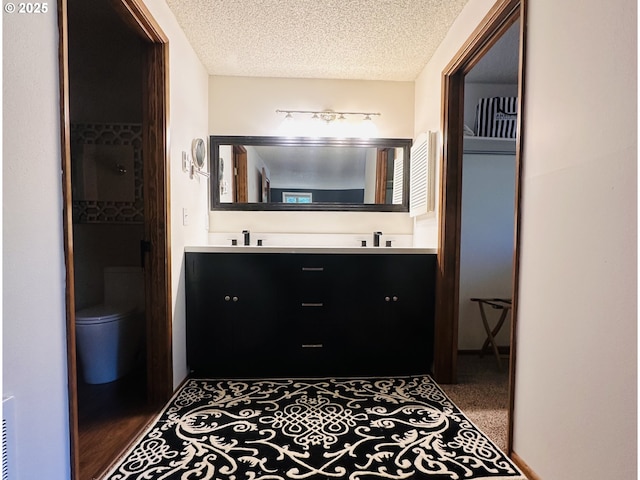 2547 Brittania Pl, Eugene, OR 97405 - bathroom featuring double vanity and a textured ceiling
