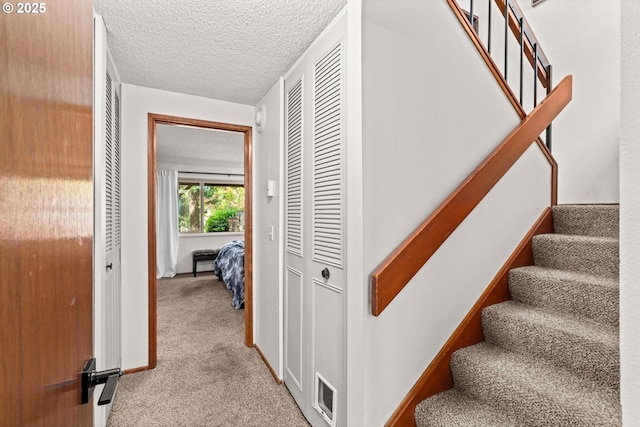 2547 Brittania Pl, Eugene, OR 97405 - corridor featuring carpet, stairway, and a textured ceiling
