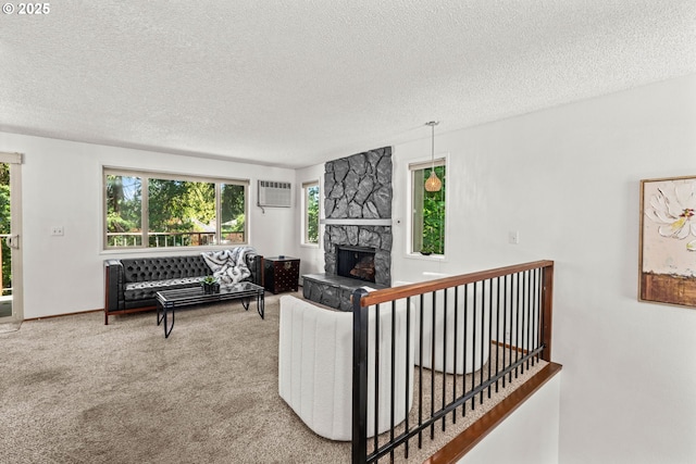 2547 Brittania Pl, Eugene, OR 97405 - living room with a textured ceiling, carpet, a fireplace, and a wall unit AC