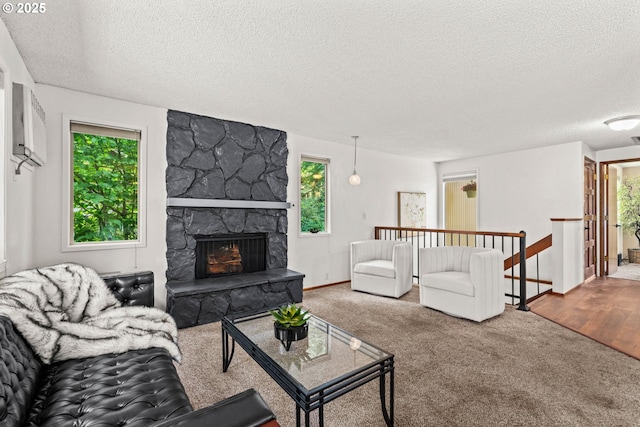 2547 Brittania Pl, Eugene, OR 97405 - living area with a textured ceiling, plenty of natural light, carpet, and a stone fireplace