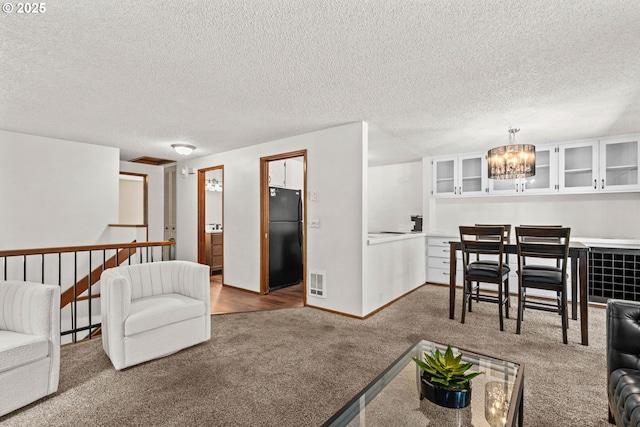 2547 Brittania Pl, Eugene, OR 97405 - living room with carpet flooring, a chandelier, and a textured ceiling