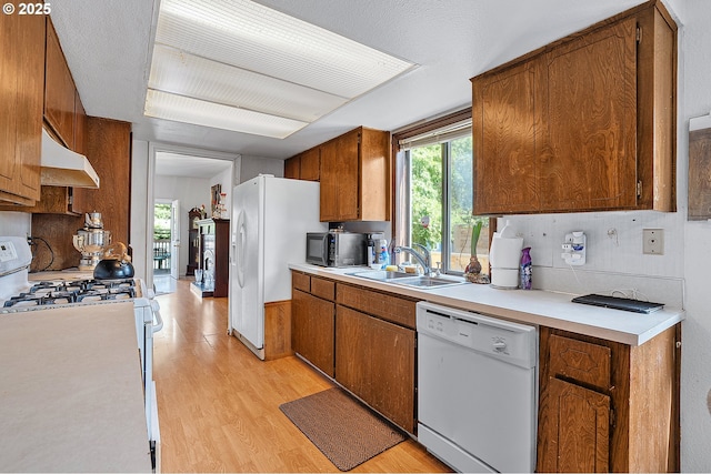 8670 SW Indian Hill Ln, Beaverton, OR 97008 - kitchen featuring white appliances, ventilation hood, light wood-style flooring, and light countertops