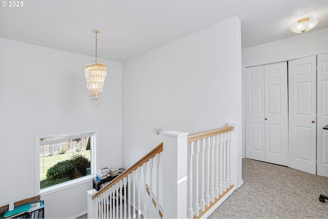 8670 SW Indian Hill Ln, Beaverton, OR 97008 - corridor featuring an upstairs landing, carpet floors, and a chandelier