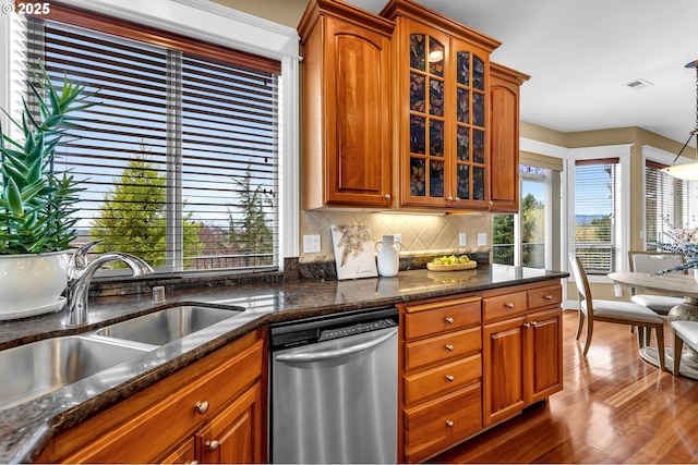 kitchen with a sink, brown cabinets, and stainless steel dishwasher