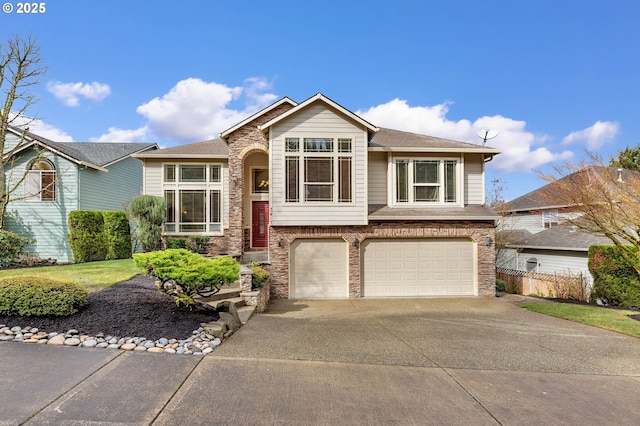 view of front facade featuring a garage, stone siding, fence, and concrete driveway