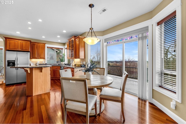 dining room with dark wood-style floors, visible vents, baseboards, and recessed lighting