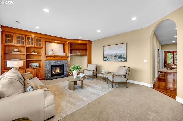 living area with a high end fireplace, carpet flooring, and recessed lighting