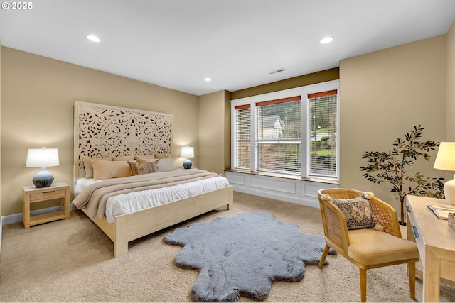 bedroom featuring recessed lighting, carpet flooring, a decorative wall, and visible vents