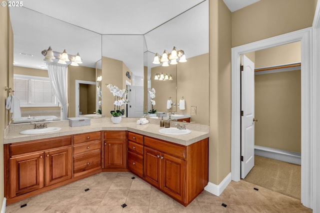 bathroom featuring double vanity, a sink, and tile patterned floors