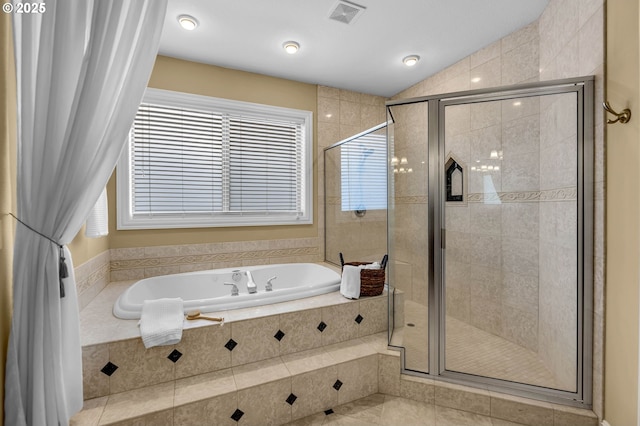 full bath with a bath, a stall shower, lofted ceiling, and visible vents