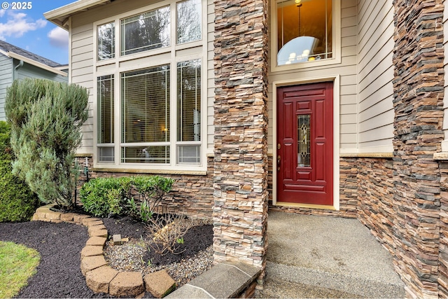 view of exterior entry featuring stone siding