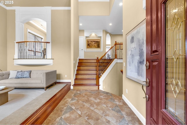 entrance foyer with stairs, baseboards, ornamental molding, and recessed lighting