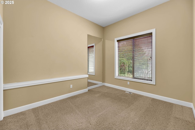 empty room with carpet and baseboards