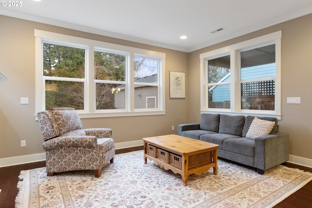 living room featuring hardwood / wood-style flooring and ornamental molding