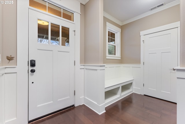 foyer entrance with dark hardwood / wood-style flooring and ornamental molding