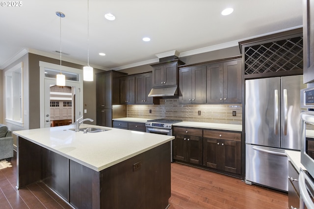 kitchen with dark brown cabinets, sink, decorative light fixtures, a kitchen island with sink, and stainless steel appliances