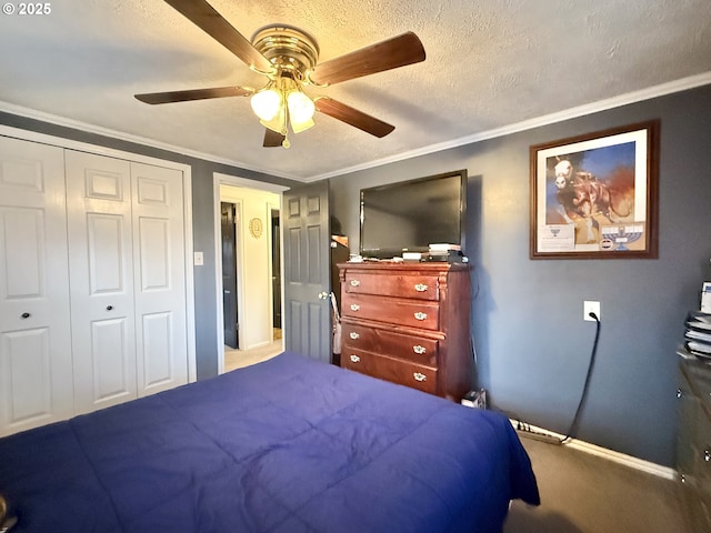 carpeted bedroom with a textured ceiling, ceiling fan, a closet, and crown molding
