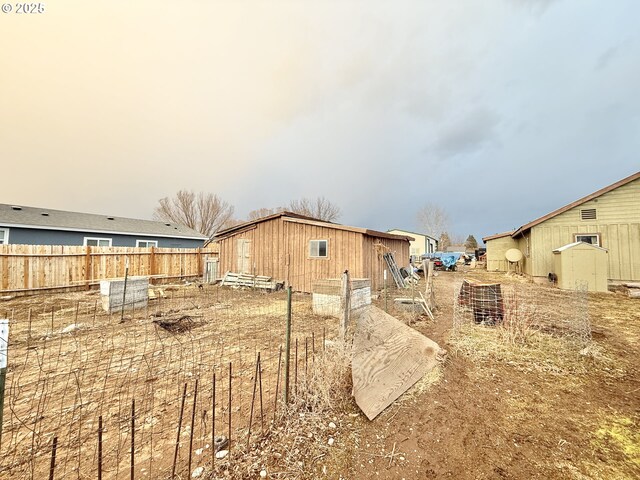 view of side of property with an outbuilding and fence