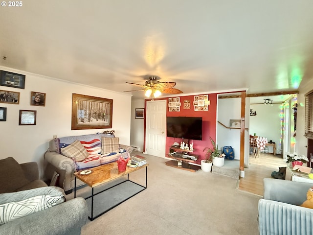 carpeted living area featuring a ceiling fan