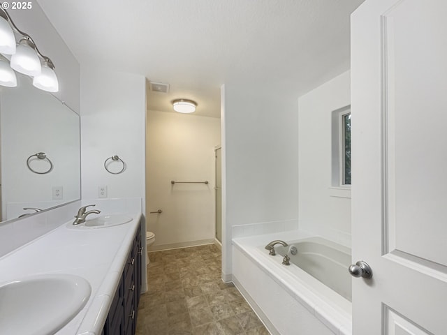 full bathroom featuring vanity, toilet, and separate shower and tub