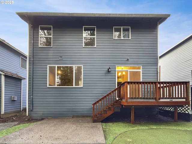 rear view of property featuring a patio and a wooden deck