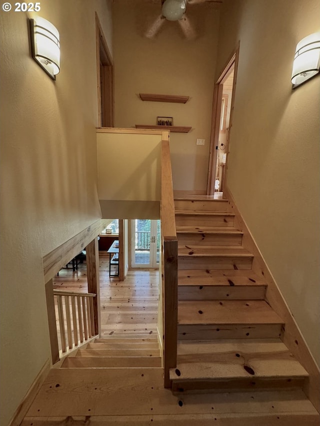 stairs featuring hardwood / wood-style floors