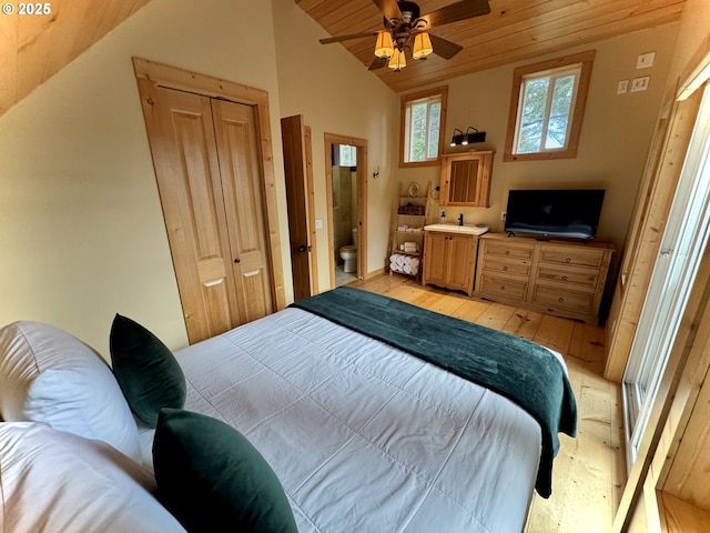 bedroom featuring vaulted ceiling, ceiling fan, wood ceiling, light wood-type flooring, and a closet