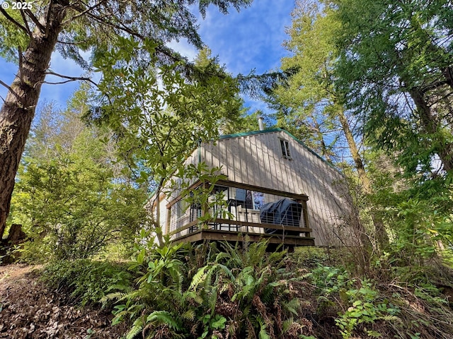 rear view of house featuring a deck