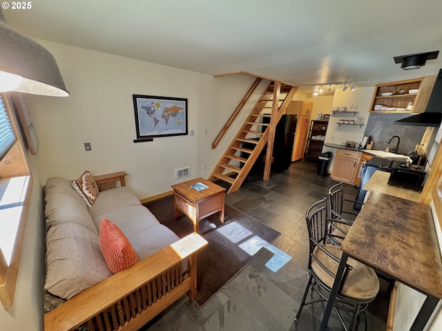 living room with sink and track lighting