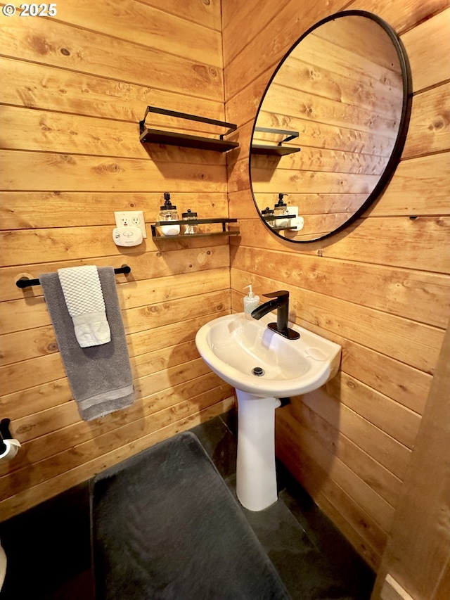 bathroom featuring wooden walls