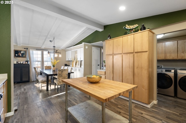 kitchen with dark hardwood / wood-style floors, pendant lighting, washer and dryer, vaulted ceiling with beams, and light brown cabinets