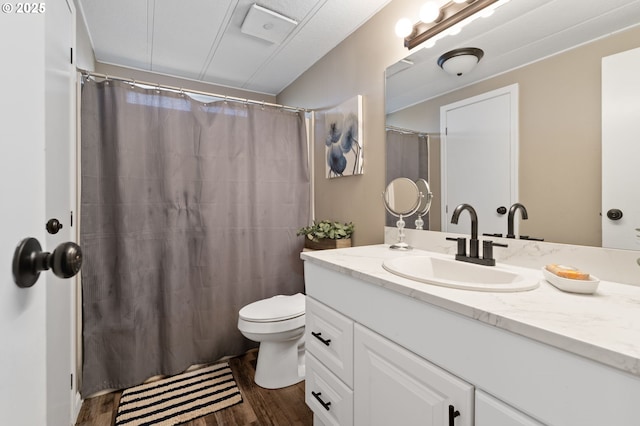 bathroom featuring vanity, hardwood / wood-style floors, curtained shower, and toilet