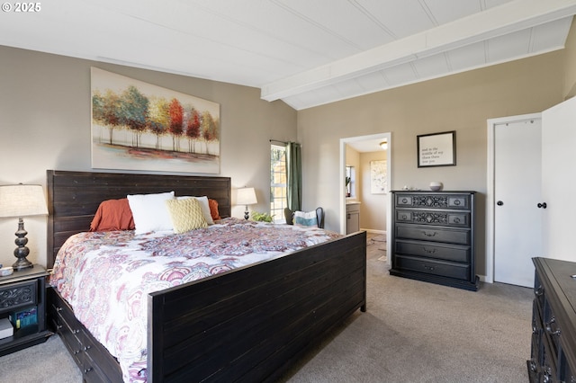 carpeted bedroom featuring connected bathroom and lofted ceiling with beams